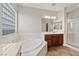Main bathroom with a soaking tub, dual vanities, and a separate shower at 11177 Twilight Times Ct, Las Vegas, NV 89135