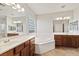 Bright bathroom features dual vanities, soaking tub, glass block window, and separate shower at 11177 Twilight Times Ct, Las Vegas, NV 89135