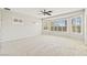 Bright main bedroom with large windows and neutral carpet flooring at 11177 Twilight Times Ct, Las Vegas, NV 89135