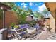 Relaxing backyard featuring a fire pit, comfortable seating, and vibrant greenery at 11340 Espadrille Ct, Las Vegas, NV 89138