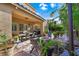 Entertainers backyard featuring multiple areas with seating, cooking and lush foliage at 11340 Espadrille Ct, Las Vegas, NV 89138