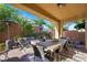 Outdoor covered patio with a dining table, fire pit, and comfortable seating area at 11340 Espadrille Ct, Las Vegas, NV 89138