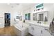 Elegant bathroom features double sinks, a soaking tub, and a separate walk-in closet with ample storage at 11340 Espadrille Ct, Las Vegas, NV 89138