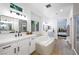 Well-lit bathroom offers double sinks, soaking tub, walk-in shower, and contemporary fixtures at 11340 Espadrille Ct, Las Vegas, NV 89138