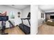 Bright home gym features modern exercise equipment, a window with shutters and a storage basket at 11340 Espadrille Ct, Las Vegas, NV 89138