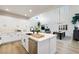 Bright kitchen featuring white cabinets, quartz countertops, stainless steel appliances, and hardwood floors at 11340 Espadrille Ct, Las Vegas, NV 89138
