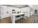 Bright kitchen with white cabinets, stainless steel appliances, quartz countertops and a large center island at 11340 Espadrille Ct, Las Vegas, NV 89138