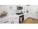 Well-equipped kitchen features white cabinets, stainless steel appliances and quartz countertops at 11340 Espadrille Ct, Las Vegas, NV 89138
