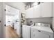 Convenient laundry room with white cabinets, modern washer and dryer, and ample storage space at 11340 Espadrille Ct, Las Vegas, NV 89138