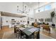 Open-concept living space featuring high ceilings, modern chandelier, hardwood floors, and abundant natural light at 11340 Espadrille Ct, Las Vegas, NV 89138
