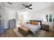 Serene bedroom with tray ceiling, hardwood floors, plantation shutters, and stylish furnishings at 11340 Espadrille Ct, Las Vegas, NV 89138