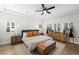 Serene bedroom with tray ceiling, hardwood floors, plantation shutters, and stylish furnishings at 11340 Espadrille Ct, Las Vegas, NV 89138
