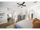 Spacious bedroom featuring hardwood floors, neutral decor, and access to ensuite bathroom and walk-in closet at 11340 Espadrille Ct, Las Vegas, NV 89138