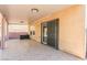 A covered back patio has a tile floor and access to the backyard at 11755 Garland Grove Ln, Las Vegas, NV 89183