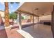 The backyard has a covered patio, trees, a shed, and a gravel ground at 11755 Garland Grove Ln, Las Vegas, NV 89183