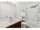 Bathroom featuring a dark wood vanity with marble countertop, sink, and shower/tub combo at 11755 Garland Grove Ln, Las Vegas, NV 89183