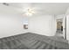 Bedroom with neutral walls, plush carpeting, ceiling fan, and ample natural light from one large window at 11755 Garland Grove Ln, Las Vegas, NV 89183