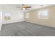 Spacious bedroom with neutral carpet, ceiling fan, and ample natural light from the shuttered windows at 11755 Garland Grove Ln, Las Vegas, NV 89183