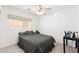 Bedroom with a ceiling fan and a window and is decorated with a gray comforter set at 11755 Garland Grove Ln, Las Vegas, NV 89183