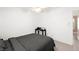 Clean bedroom featuring neutral paint, a ceiling fan, and light colored tile at 11755 Garland Grove Ln, Las Vegas, NV 89183
