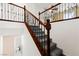 Elegant staircase with carpeted steps, decorative wood and metal railing, and bright, natural light at 11755 Garland Grove Ln, Las Vegas, NV 89183