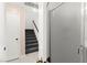 Interior staircase featuring carpeted stairs, white walls, and a light tiled floor at 11755 Garland Grove Ln, Las Vegas, NV 89183