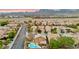 Overhead shot showing a home with a pool and covered patio in a neighborhood surrounded by desert landscape at 1200 Dream Bridge Dr, Las Vegas, NV 89144