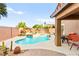 Backyard with pool, water feature, patio furniture, and desert landscaping at 1200 Dream Bridge Dr, Las Vegas, NV 89144