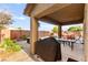 Outdoor patio area featuring a barbecue grill, dining set, lush vegetation, and a pool with a grotto at 1200 Dream Bridge Dr, Las Vegas, NV 89144