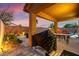 Covered backyard patio with bbq and a view of the pool makes outdoor dining easy at 1200 Dream Bridge Dr, Las Vegas, NV 89144