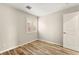 Cozy bedroom featuring wood-look tile flooring, a window with shutters and neutral walls at 1200 Dream Bridge Dr, Las Vegas, NV 89144