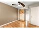Bright bedroom featuring hardwood floors, ceiling fan, and closet with a rustic wood barn door at 1200 Dream Bridge Dr, Las Vegas, NV 89144