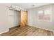 Bright bedroom with wood-look flooring and a decorative barn door at 1200 Dream Bridge Dr, Las Vegas, NV 89144