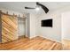 Bedroom featuring hardwood floors, and a sliding barn door to the closet at 1200 Dream Bridge Dr, Las Vegas, NV 89144