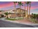 The home's exterior is beautifully landscaped, highlighting the inviting curb appeal and architecture at 1200 Dream Bridge Dr, Las Vegas, NV 89144