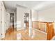 Upstairs hallway featuring hardwood floors and white doors with a bathroom and bedroom view at 1200 Dream Bridge Dr, Las Vegas, NV 89144