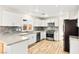 Bright kitchen with white cabinets, stainless steel appliances, and wood-look flooring at 1200 Dream Bridge Dr, Las Vegas, NV 89144