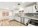 Bright kitchen with stainless appliances, wood-look flooring and a view out the window at 1200 Dream Bridge Dr, Las Vegas, NV 89144