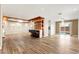 Spacious living room featuring wood-look tile flooring, recessed lighting, and a stylish bar with seating overlooking the pool at 1200 Dream Bridge Dr, Las Vegas, NV 89144