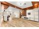 Open-concept living area featuring a stylish bar, custom media center, and wood-look tile, perfect for entertaining and relaxation at 1200 Dream Bridge Dr, Las Vegas, NV 89144