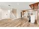 Open living space showcasing wood-look tile flooring, a staircase, and a modern bar area for entertaining guests at 1200 Dream Bridge Dr, Las Vegas, NV 89144