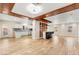 Spacious open-concept living area with wood-look floors, bar seating, and easy access to the kitchen, perfect for hosting at 1200 Dream Bridge Dr, Las Vegas, NV 89144