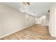 Open living room featuring a modern chandelier, staircase, and wood-look flooring at 1200 Dream Bridge Dr, Las Vegas, NV 89144