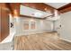 Bright living room with wood-look tile flooring, recessed lights, and large windows, offering a cozy and inviting atmosphere at 1200 Dream Bridge Dr, Las Vegas, NV 89144