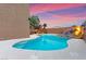 Beautiful backyard pool with cool, clear water, a rock spa, and lovely desert landscaping at 1200 Dream Bridge Dr, Las Vegas, NV 89144