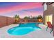 The kidney-shaped backyard pool features a small water fall and spa at 1200 Dream Bridge Dr, Las Vegas, NV 89144