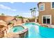 Beautiful backyard oasis featuring a pool with rock features, and a hot tub at 1200 Dream Bridge Dr, Las Vegas, NV 89144