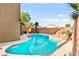Backyard pool featuring a rock grotto, spa, and desert landscaping for relaxing outdoor living at 1200 Dream Bridge Dr, Las Vegas, NV 89144