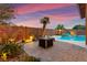 Backyard pool and fire pit create an inviting space for relaxing and entertaining outdoors at 1200 Dream Bridge Dr, Las Vegas, NV 89144