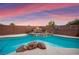 The private backyard pool includes a rock waterfall feature, surrounded by a secure brick fence at 1200 Dream Bridge Dr, Las Vegas, NV 89144